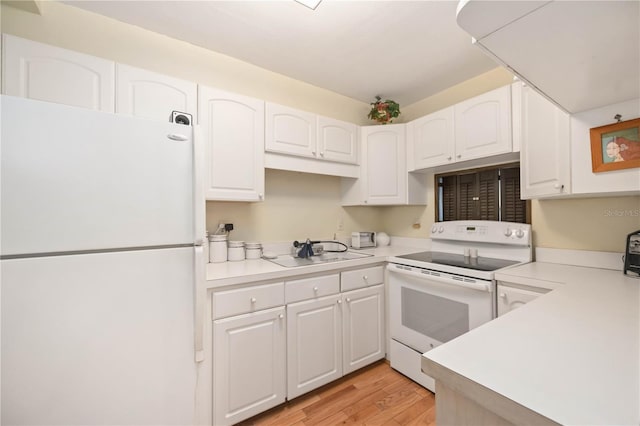 kitchen featuring white cabinetry, white appliances, and sink