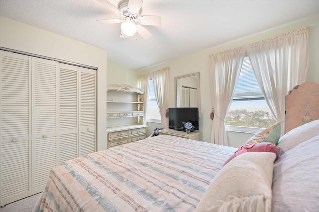 carpeted bedroom featuring a textured ceiling and ceiling fan