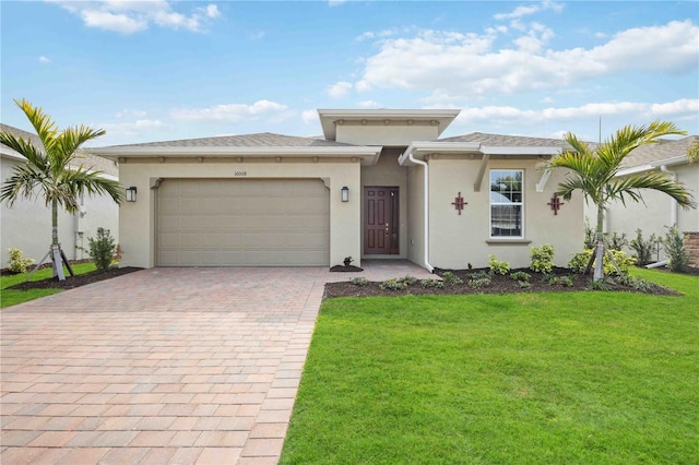 view of front of house featuring a garage and a front lawn