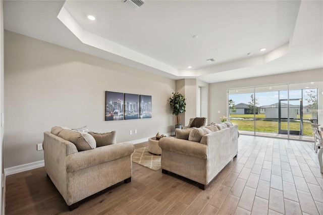 living room featuring a tray ceiling