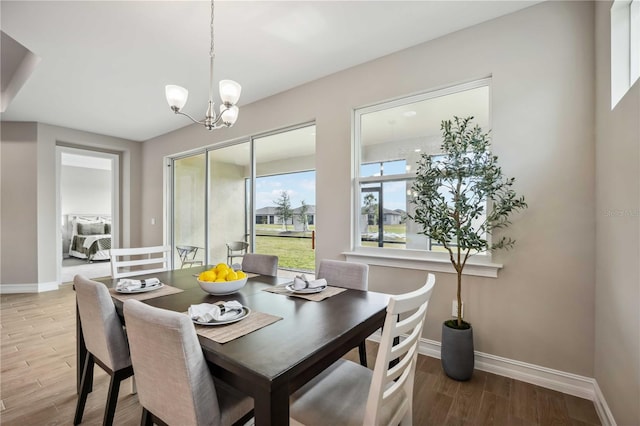 dining space with an inviting chandelier