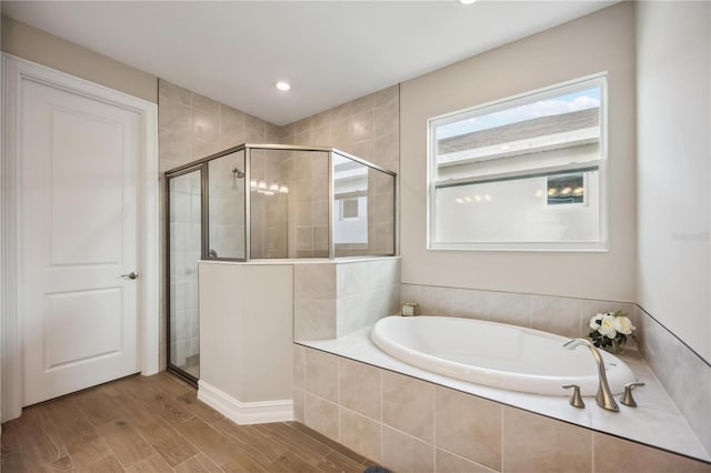 bathroom featuring shower with separate bathtub