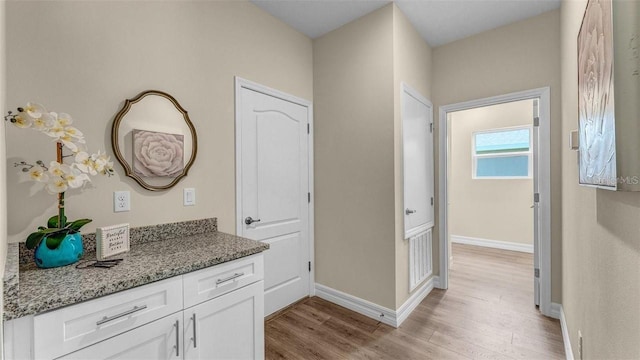 hallway with light hardwood / wood-style floors