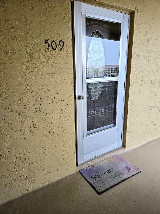 view of exterior entry with stucco siding