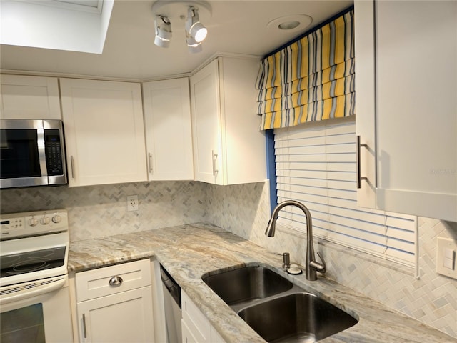 kitchen featuring decorative backsplash, white cabinetry, and stainless steel appliances