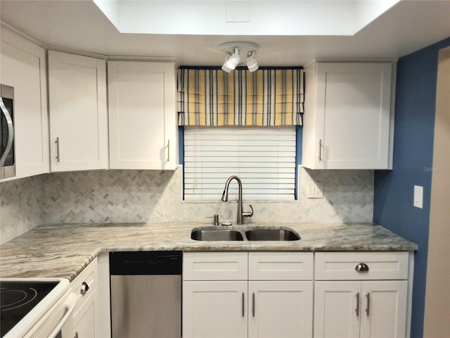 kitchen featuring sink, white cabinetry, backsplash, and stainless steel appliances