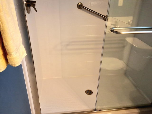 bathroom with a shower with door