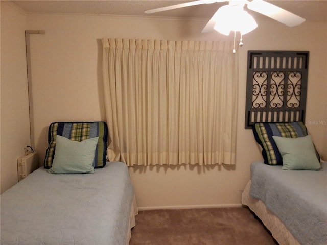 bedroom with ceiling fan, crown molding, and carpet flooring