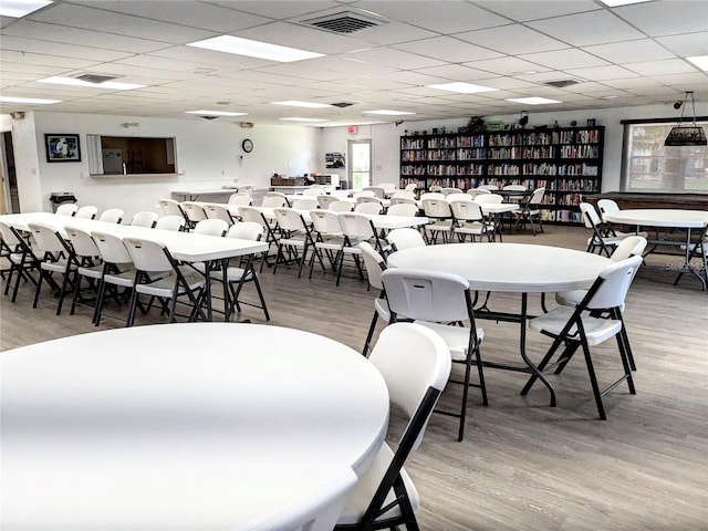 dining area featuring hardwood / wood-style flooring and a drop ceiling