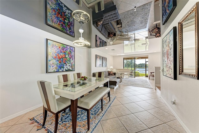 dining room featuring a high ceiling and light tile patterned floors