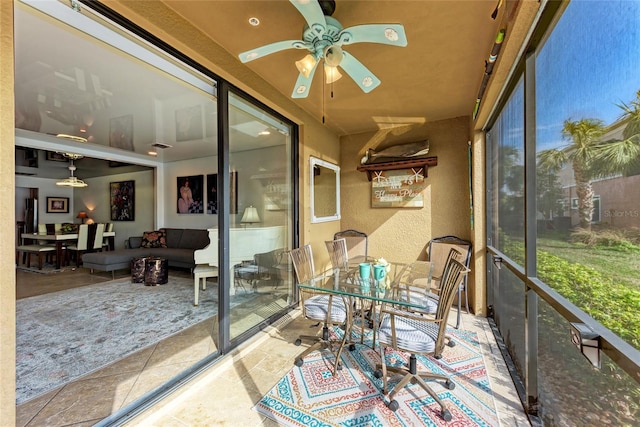 sunroom / solarium featuring ceiling fan