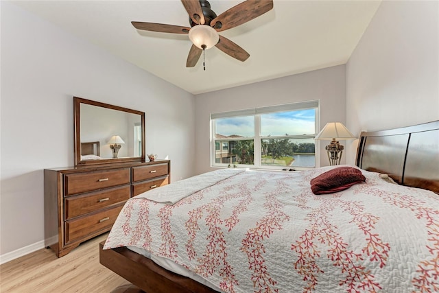 bedroom with ceiling fan and light hardwood / wood-style flooring