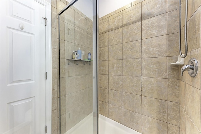 bathroom with a shower with shower door