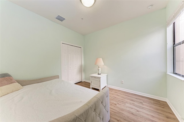 bedroom featuring a closet and light hardwood / wood-style flooring