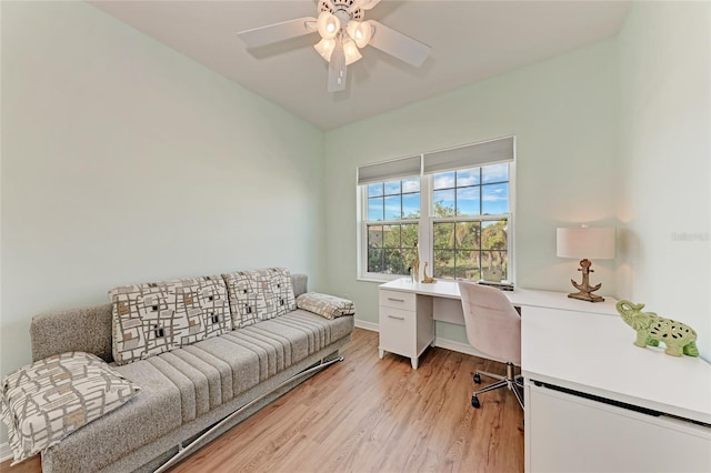 office with light hardwood / wood-style floors and ceiling fan