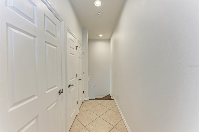 corridor with light tile patterned flooring