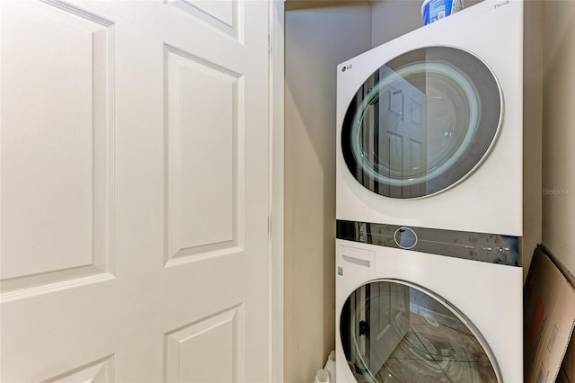 laundry area featuring stacked washer and dryer