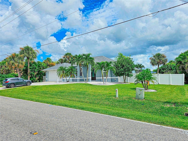 view of front of property with a garage and a front yard