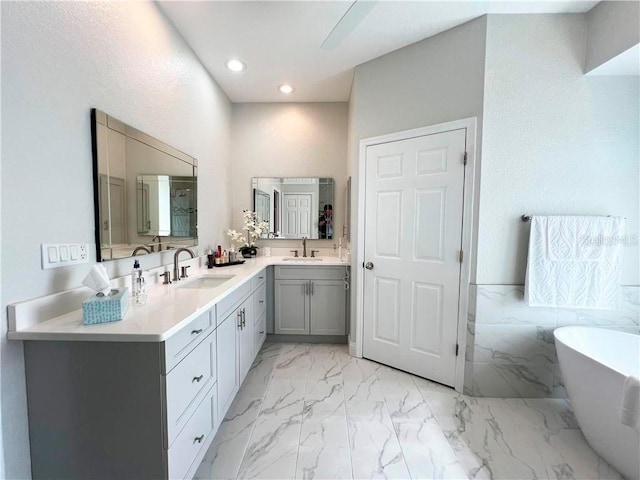 bathroom featuring a bath and vanity