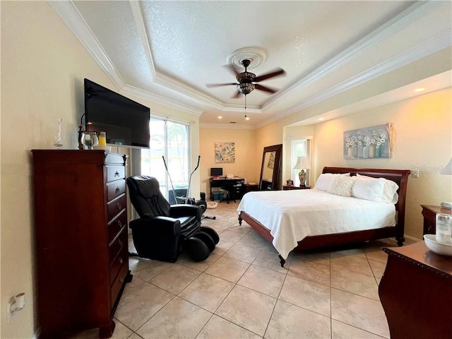 tiled bedroom featuring ceiling fan, ornamental molding, and a raised ceiling