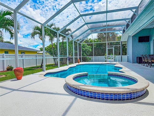 view of swimming pool with a lanai, a patio area, and an in ground hot tub