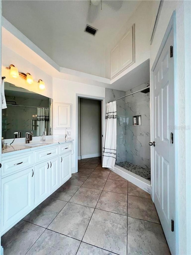 bathroom with vanity, tile patterned flooring, and walk in shower