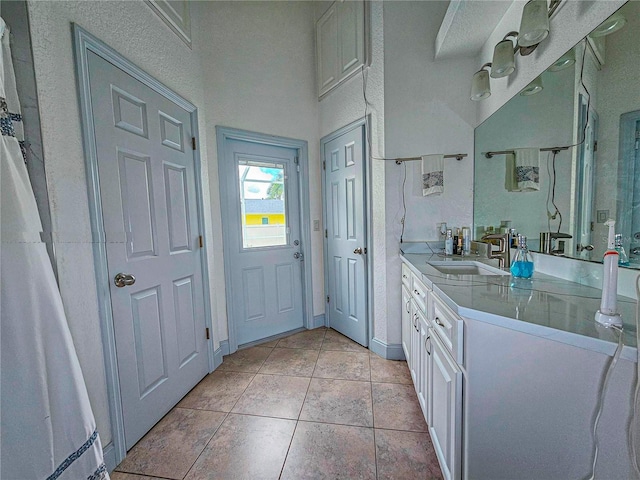 bathroom featuring tile patterned flooring and vanity