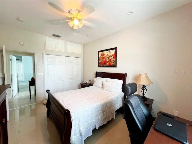 tiled bedroom with ceiling fan and a closet