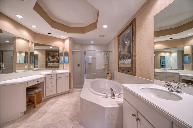 bathroom with a raised ceiling, ornamental molding, separate shower and tub, and vanity