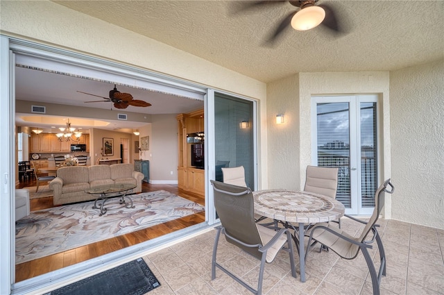 view of patio featuring ceiling fan and french doors