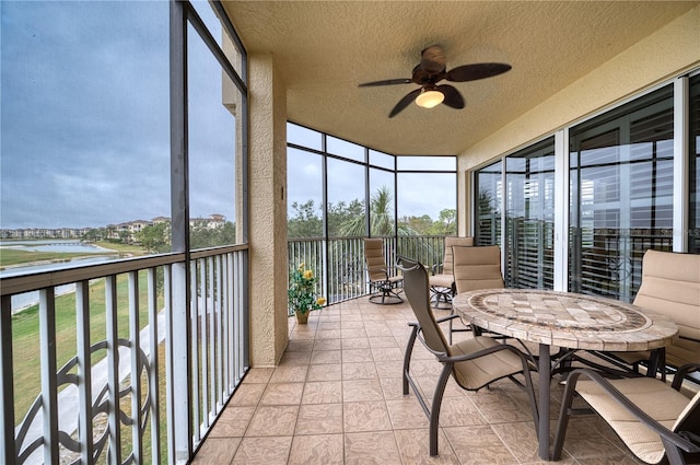 sunroom featuring ceiling fan