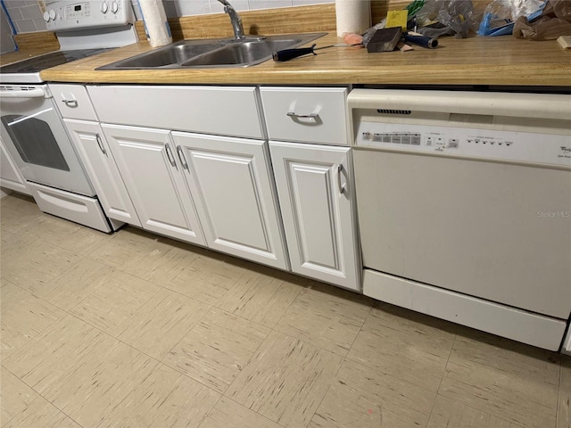 kitchen with sink, white appliances, and white cabinets