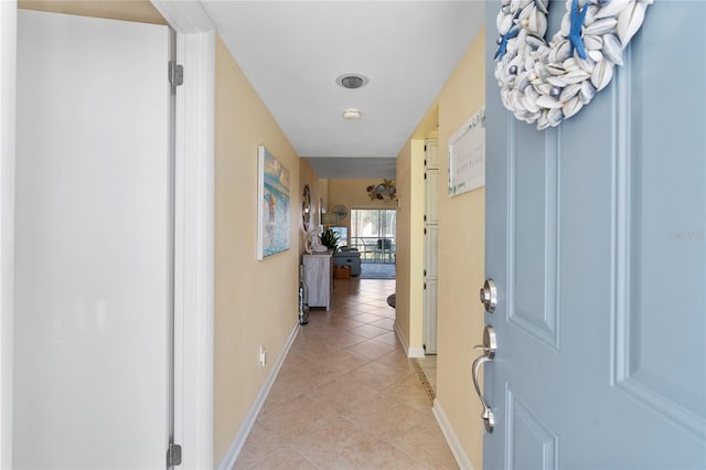 hall with light tile patterned floors