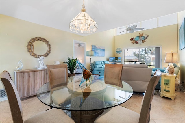 dining room with ceiling fan with notable chandelier and light tile patterned floors