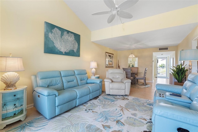 living room with lofted ceiling, light tile patterned floors, and ceiling fan