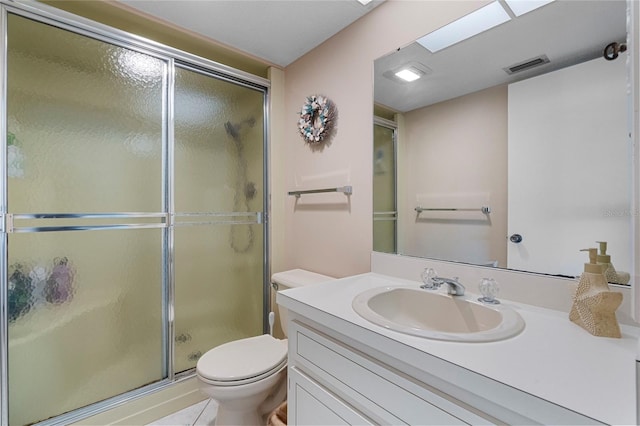 bathroom featuring vanity, an enclosed shower, tile patterned floors, and toilet