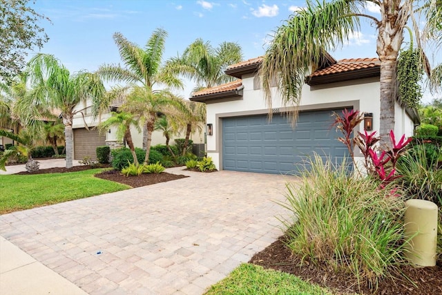 mediterranean / spanish-style home with a garage