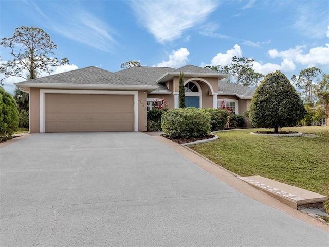 view of front of property featuring a garage and a front yard