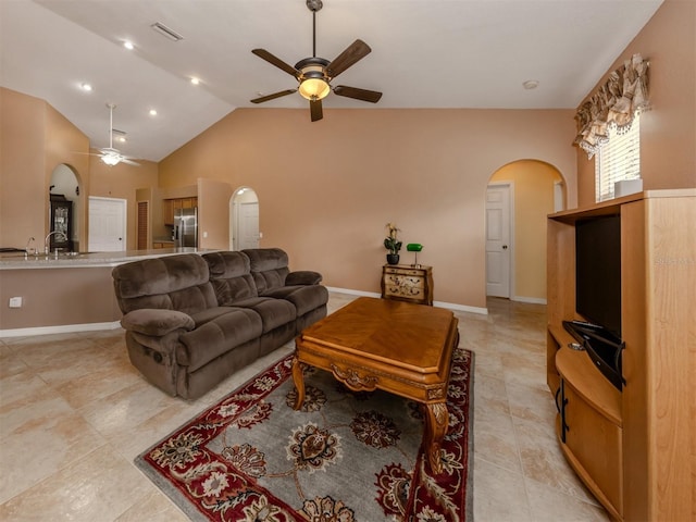 living room with ceiling fan and lofted ceiling