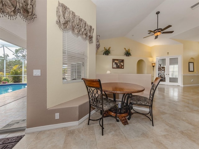 dining space featuring ceiling fan, french doors, and lofted ceiling