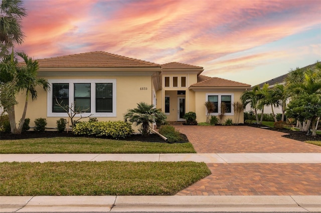 mediterranean / spanish house featuring a lawn