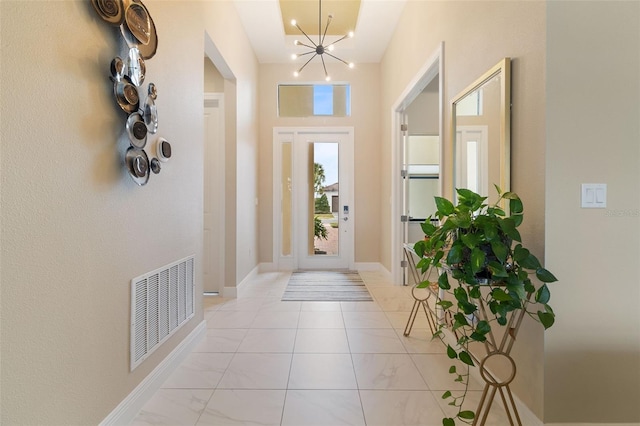 doorway to outside featuring a notable chandelier