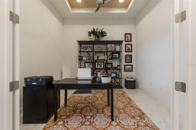 home office featuring a raised ceiling