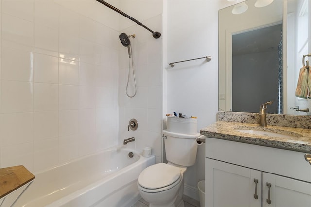 full bathroom with tiled shower / bath, vanity, and toilet