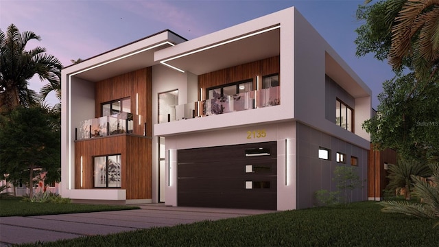 contemporary house featuring a garage and a balcony