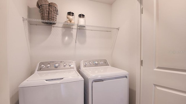 clothes washing area with washing machine and clothes dryer