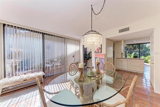 tiled dining room with a notable chandelier