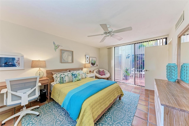 bedroom with tile patterned flooring, access to exterior, a wall of windows, and ceiling fan