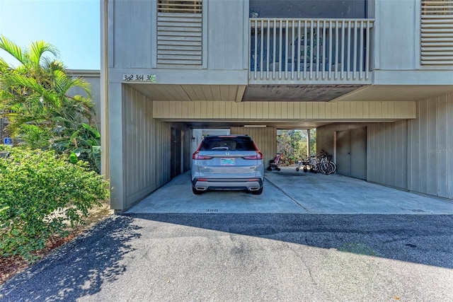 view of parking / parking lot with a carport and driveway