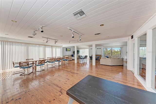 interior space featuring wood ceiling, track lighting, and hardwood / wood-style flooring